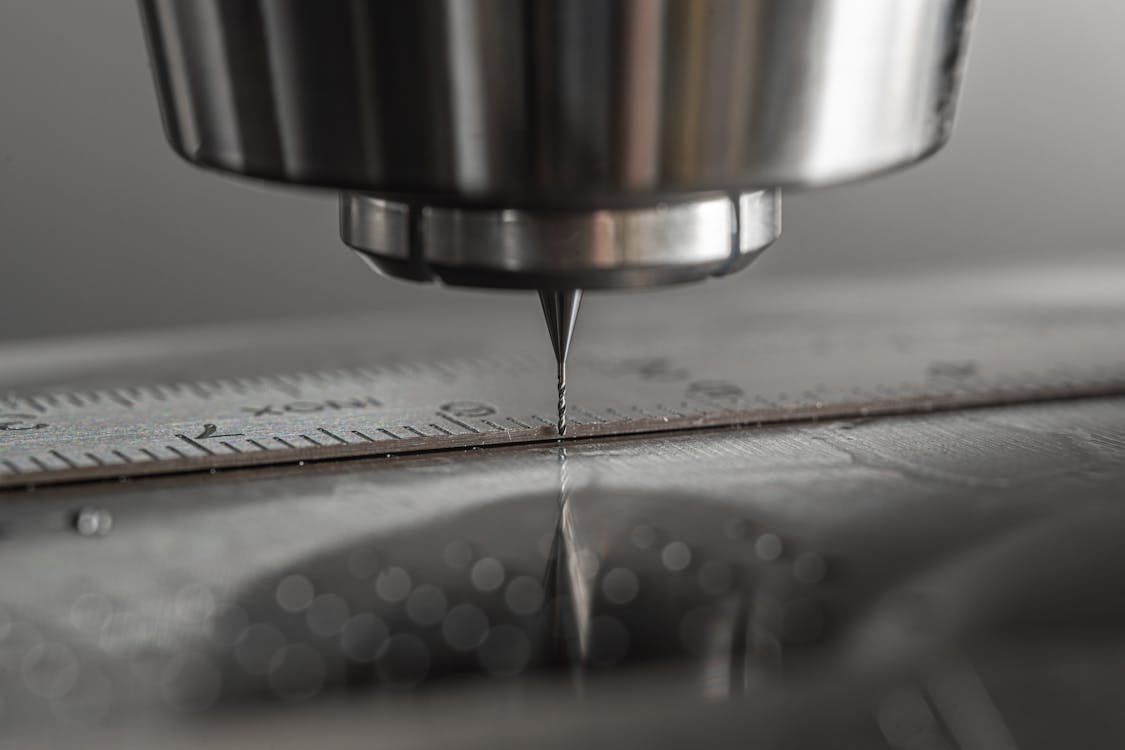 Close-up of a CNC milling machine with precision drill bit on a metal workpiece