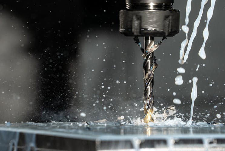 CNC machining with metalworking fluid in action